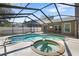 Beautiful backyard pool area with a screened enclosure, hot tub and patio at 4034 Paddlewheel Dr, Brandon, FL 33511