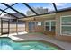 Screened-in pool area with a spa and a covered patio featuring a ceiling fan and mounted television at 4034 Paddlewheel Dr, Brandon, FL 33511