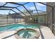 Large screened-in pool features an attached spa and patio seating area at 4034 Paddlewheel Dr, Brandon, FL 33511