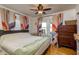 Bedroom with wood floors, a ceiling fan, and colorful curtains at 4334 18Th N St, St Petersburg, FL 33714