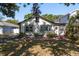 Inviting home exterior with a charming entrance, complemented by verdant landscaping and mature trees at 4334 18Th N St, St Petersburg, FL 33714