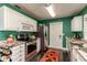Eat-in kitchen with stainless appliances, granite counters, white cabinets and green walls at 4334 18Th N St, St Petersburg, FL 33714
