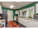 Bright kitchen with white cabinets, granite countertops, stainless steel appliances, and dark tile floors at 4334 18Th N St, St Petersburg, FL 33714