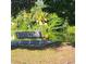 Relaxing park bench facing a tranquil pond with lush greenery and palm trees offering a serene escape at 4334 18Th N St, St Petersburg, FL 33714