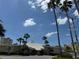 Exterior view of a clubhouse, surrounded by lush palm trees under a clear blue sky at 4725 Cove Cir # 604, St Petersburg, FL 33708