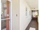Hallway of condo building with view into apartment unit with white cabinets and tile floors at 4725 Cove Cir # 604, St Petersburg, FL 33708