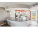 Bright kitchen featuring stainless steel appliances, white cabinetry, breakfast bar and a view from the balcony at 4725 Cove Cir # 604, St Petersburg, FL 33708