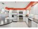 Bright kitchen featuring stainless steel appliances, white cabinetry, breakfast bar and a view into the living room at 4725 Cove Cir # 604, St Petersburg, FL 33708