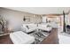 Comfortable living room features a plush white sectional, glass coffee table and dark hardwood floors at 4725 Cove Cir # 604, St Petersburg, FL 33708