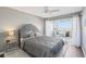 Comfortable bedroom featuring a queen size bed, ceiling fan and a private balcony with water views at 4725 Cove Cir # 604, St Petersburg, FL 33708
