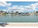 Waterfront view of colorful homes and private docks under a blue sky with puffy clouds at 4725 Cove Cir # 604, St Petersburg, FL 33708