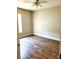 Cozy bedroom featuring wood-look flooring and natural light at 4801 Haines N Rd, St Petersburg, FL 33714