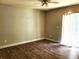 Spacious bedroom featuring a ceiling fan, natural light, and wood-look flooring at 4801 Haines N Rd, St Petersburg, FL 33714