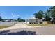 The home's exterior showing a driveway, white picket fence, and manicured shrubbery at 4801 Haines N Rd, St Petersburg, FL 33714