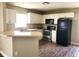 Functional kitchen featuring white cabinets, stainless steel appliances, and ample countertop space at 4801 Haines N Rd, St Petersburg, FL 33714