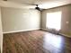 Bright living room with ceiling fan, natural light, and wood-look flooring at 4801 Haines N Rd, St Petersburg, FL 33714