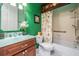 Well-lit bathroom with vanity, stylish mirror, and a shower-tub combination with a decorative shower curtain at 5429 Legend Hills Ln, Spring Hill, FL 34609