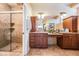 Bathroom with tiled shower, dual vanity, and granite countertops at 5429 Legend Hills Ln, Spring Hill, FL 34609