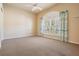 Bright bedroom features neutral colors, arched window with shutters, and carpeted flooring at 5429 Legend Hills Ln, Spring Hill, FL 34609