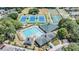 Aerial view showcasing community pool, tennis courts, pickleball courts, basketball court, and clubhouse at 5429 Legend Hills Ln, Spring Hill, FL 34609