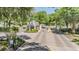 Gated community entrance with brick columns, meticulous landscaping, and well-maintained brick-paved road at 5429 Legend Hills Ln, Spring Hill, FL 34609
