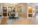 Elegant dining area with a chandelier and view of the outdoor pool at 5429 Legend Hills Ln, Spring Hill, FL 34609
