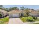 Charming single story home with a brick driveway and manicured landscaping at 5429 Legend Hills Ln, Spring Hill, FL 34609