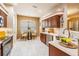 Eat-in kitchen with wood cabinetry, tile backsplash, and granite countertops at 5429 Legend Hills Ln, Spring Hill, FL 34609