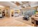 Open concept living room with hardwood floors flowing into an adjacent dining area, perfect for entertaining at 5429 Legend Hills Ln, Spring Hill, FL 34609