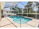 Inviting swimming pool with a screened enclosure and stone patio for outdoor relaxation at 5429 Legend Hills Ln, Spring Hill, FL 34609