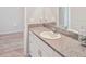 Bright bathroom vanity featuring a granite countertop and white cabinets at 5457 Leslie Canyon Dr, Wimauma, FL 33598