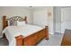 Comfortable bedroom featuring a full bed with decorative pillows, a closet, and neutral tones at 5457 Leslie Canyon Dr, Wimauma, FL 33598