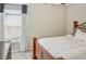 Cozy bedroom featuring neutral tones, a comfortable bed, and a window with light-filtering blinds and curtains at 5457 Leslie Canyon Dr, Wimauma, FL 33598