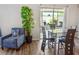 Dining room with modern glass table and high-back chairs and access to patio at 5457 Leslie Canyon Dr, Wimauma, FL 33598