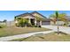 A single-story home featuring a well-maintained lawn, landscaping, and a two-car garage at 5457 Leslie Canyon Dr, Wimauma, FL 33598