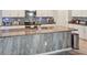Modern kitchen island with granite countertop and stainless steel appliances, well-lit and stylish at 5457 Leslie Canyon Dr, Wimauma, FL 33598