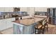 Modern kitchen featuring stainless appliances, sleek countertops, and an island with barstool seating at 5457 Leslie Canyon Dr, Wimauma, FL 33598