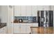 Modern kitchen with stainless steel appliances and granite countertops with ample storage at 5457 Leslie Canyon Dr, Wimauma, FL 33598