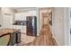 Well-lit kitchen with modern stainless steel appliances, white cabinetry, and granite countertops at 5457 Leslie Canyon Dr, Wimauma, FL 33598