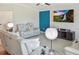 Relaxing living room area with reclining seating, blue accent wall, and entertainment center at 5457 Leslie Canyon Dr, Wimauma, FL 33598