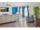 Comfortable living room with stylish décor, entertainment setup, and view of the front windows at 5457 Leslie Canyon Dr, Wimauma, FL 33598