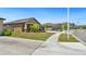 A neighborhood street featuring sidewalks, street lamps and similarly styled homes at 5457 Leslie Canyon Dr, Wimauma, FL 33598