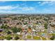 Expansive aerial view of a residential neighborhood with single-Gathering homes and lush greenery under a blue sky at 6010 Blossom Ave, Tampa, FL 33614