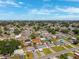 An aerial showcases a residential area with charming houses and tree-lined streets on a sunny day at 6010 Blossom Ave, Tampa, FL 33614
