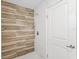 Modern bathroom featuring stylish rainfall shower head and decorative wood-look tile accent at 6010 Blossom Ave, Tampa, FL 33614