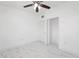 Bright bedroom with updated ceiling fan, closet, and sleek tile flooring at 6010 Blossom Ave, Tampa, FL 33614