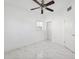 Cozy bedroom features new tile floors, a ceiling fan, and a closet at 6010 Blossom Ave, Tampa, FL 33614
