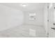Sunny room featuring updated tile flooring, a window and door at 6010 Blossom Ave, Tampa, FL 33614