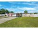 Inviting one-story home featuring a carport and well-maintained lawn at 6010 Blossom Ave, Tampa, FL 33614