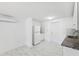 Bright kitchen featuring white cabinets, granite countertops, and modern flooring at 6010 Blossom Ave, Tampa, FL 33614